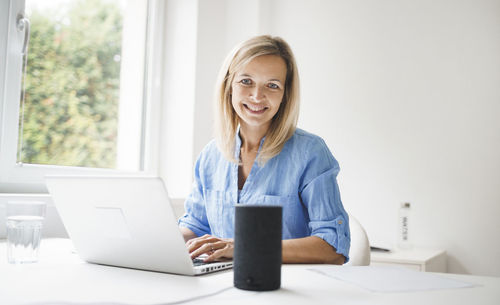 Portrait of woman working on laptop in office