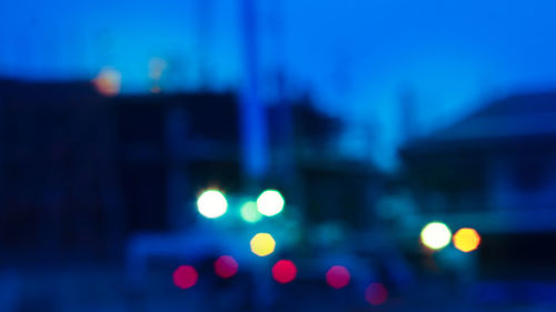 Defocused image of illuminated city at night