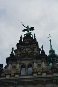 Low angle view of historical building against cloudy sky