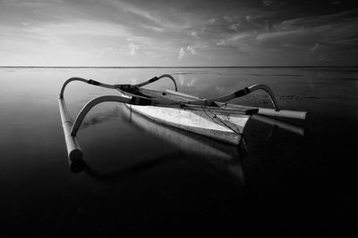 Boat moored in sea against sky