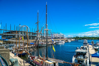 Sailboats moored in harbor