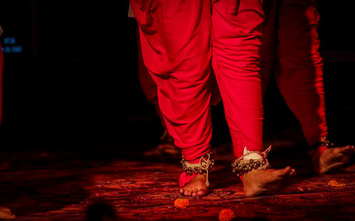 Low section of woman standing on red stage