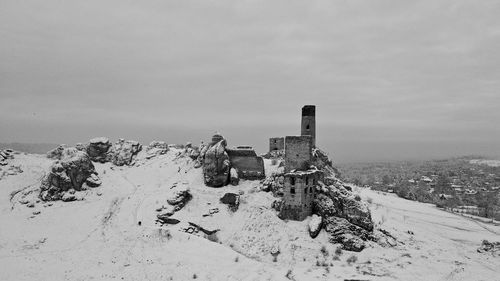 Abandoned built structure on snow covered landscape