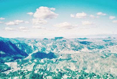 Scenic view of sea and mountains against sky