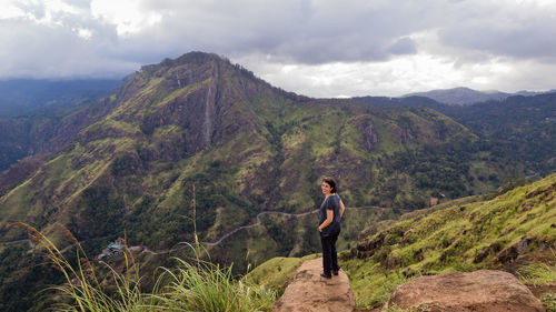 High angle view of woman standing adams peak against cloudy sky