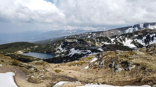 Scenic view of lake and mountains against sky