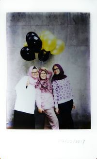 Portrait of young woman with balloons