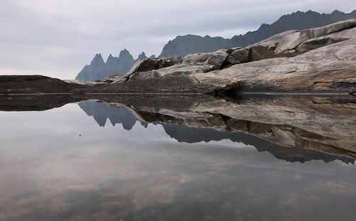 Scenic view of lake and mountains against sky