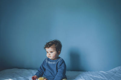 Girl looking away on bed at home