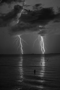 Lightning over sea against sky