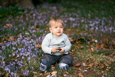 Cute girl sitting on field