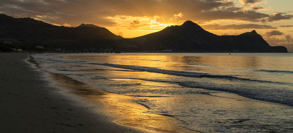 Scenic view of beach against sky during sunset