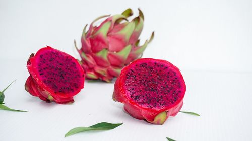 Close-up of strawberries on table against white background