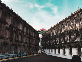 Street amidst buildings against sky in city