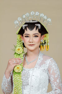 Beautiful model, wearing javanese indonesian wedding dress.