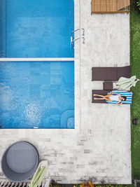 Aerial view of attractive woman near the pool at resort