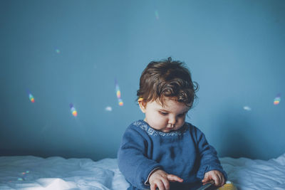 Cute baby girl on bed at home