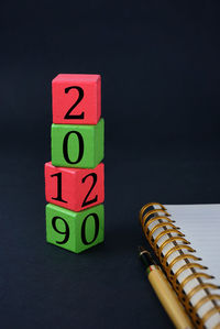 Close-up of toys on table against black background