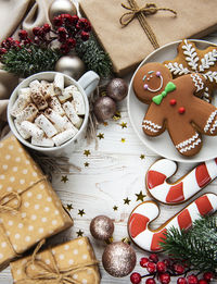 Christmas background with gift box, cocoa and gingerbread cookies. white wooden background.