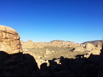 Scenic view of mountains against clear blue sky