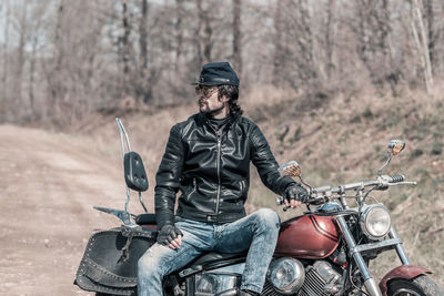 Man riding motorcycle on road