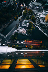 High angle view of illuminated city street and buildings at night