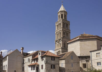 Low angle view of buildings against blue sky