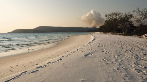 Scenic view of beach against sky during sunset