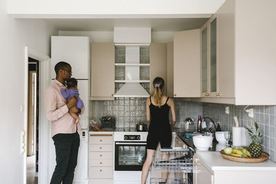 Parents with baby in kitchen