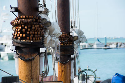 Close-up of ship at harbor against sky