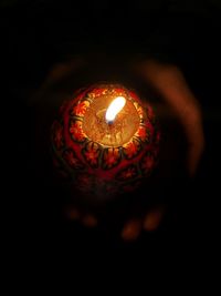 Close-up of illuminated lamp against black background