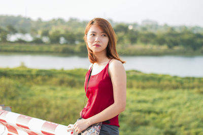 Portrait of woman standing on field