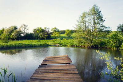 Pier over lake against sky