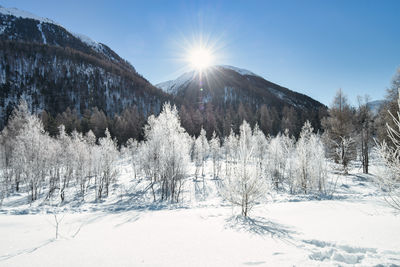 Panoramic view of snow covered mountains against sky
