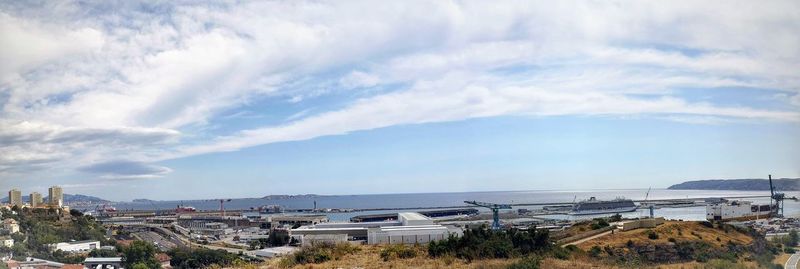 High angle view of buildings by sea against sky