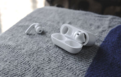 Close-up of wedding rings on bed