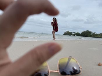 People at beach against sky