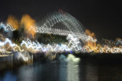 Firework display over river at night