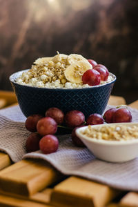 Plate of cottage cheese with granola, oatmeal, grapes, banana. healthy, delicious food for breakfast