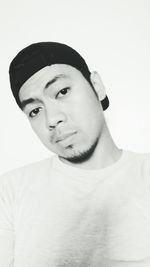 Portrait of young man against white background