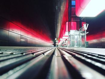 Illuminated railroad tracks in city