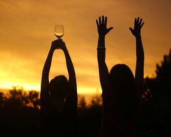 Silhouette of people at sunset