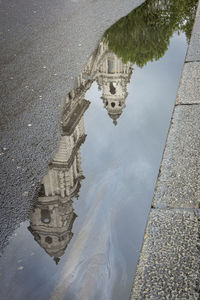 Reflection of building in puddle