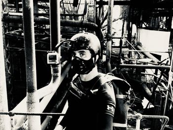 Portrait of man standing on metal structure