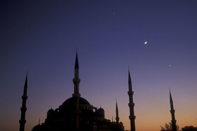 Low angle view of buildings against sky at night