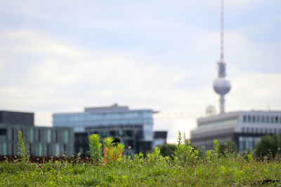 View of modern buildings against cloudy sky