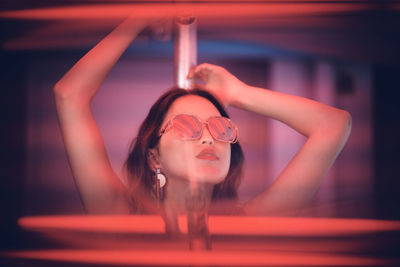 Close-up portrait of young woman wearing sunglasses