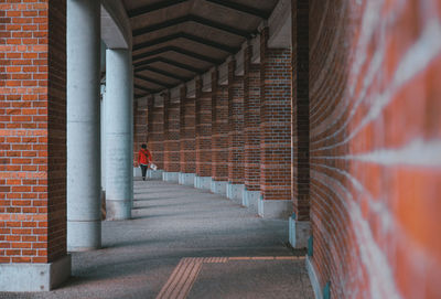 Man walking in corridor of building