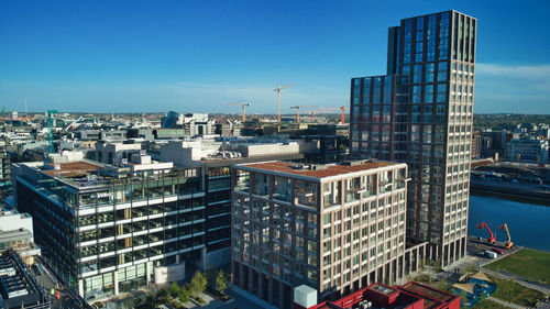 High angle view of buildings against blue sky