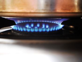 Close-up of lit candle in kitchen